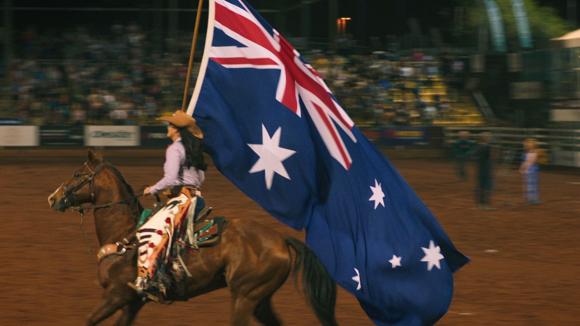 Woman Riding A Horse Carrying An Australian Flag.