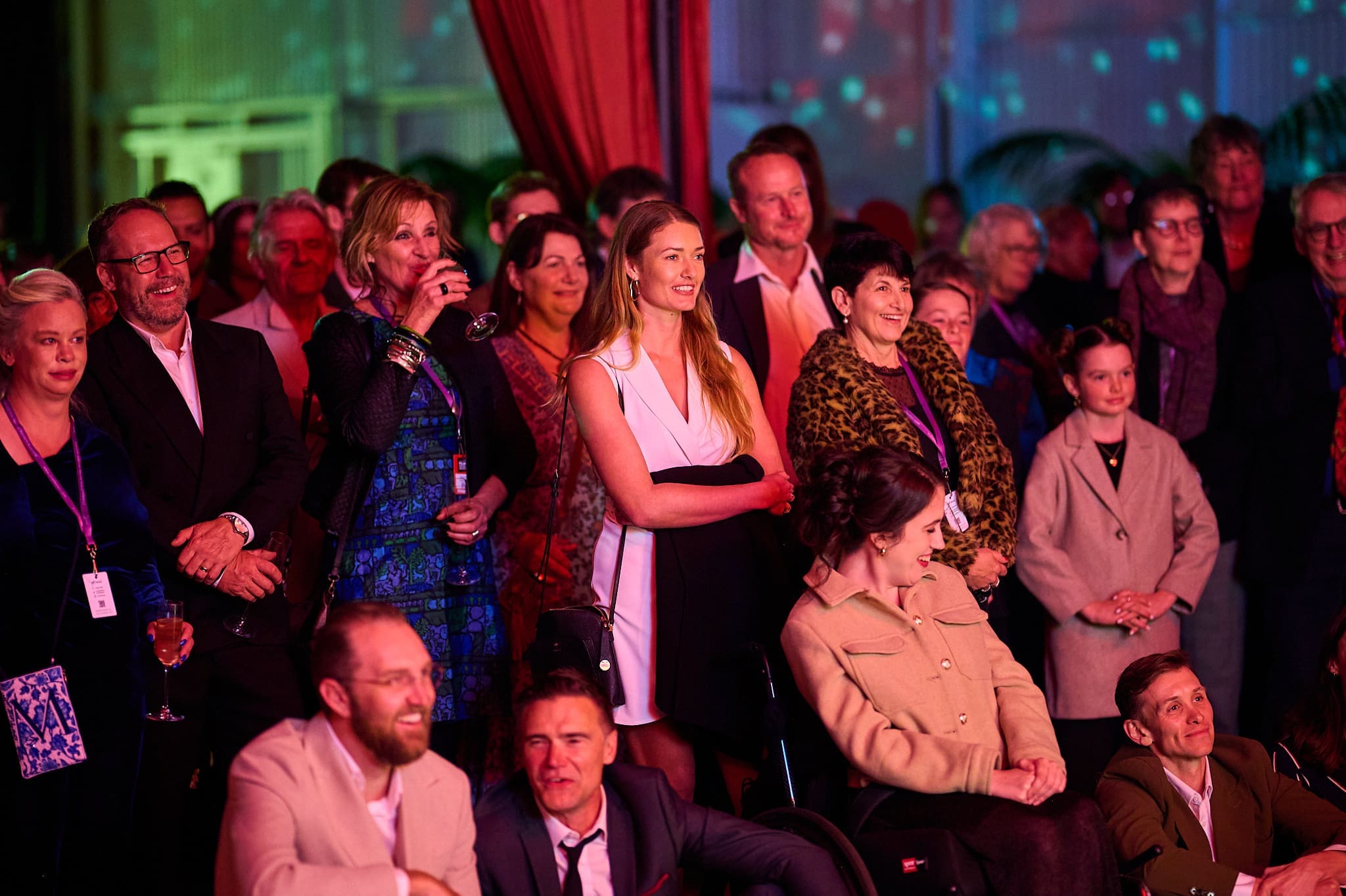 Smiling Crowd Watching An Awards Ceremony.
