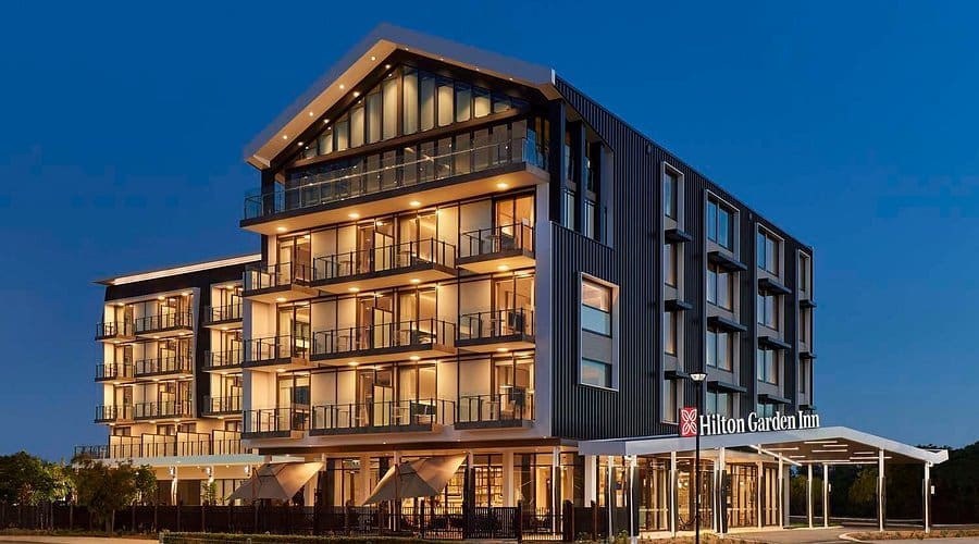 Hotel At Dusk With The Lights Glowing.